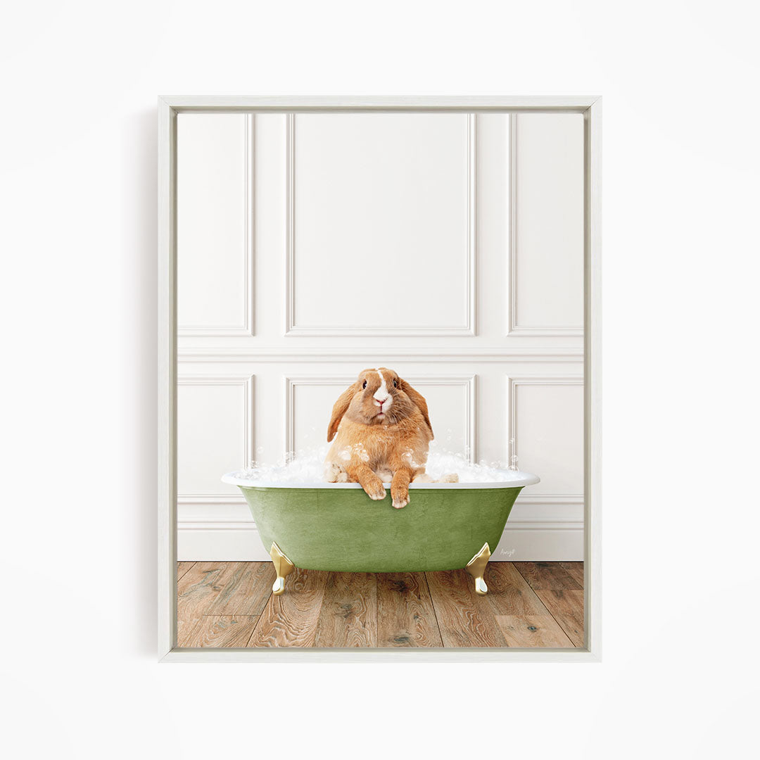 A brown rabbit sitting in a green bathtub filled with bubbles, looking directly at the camera.