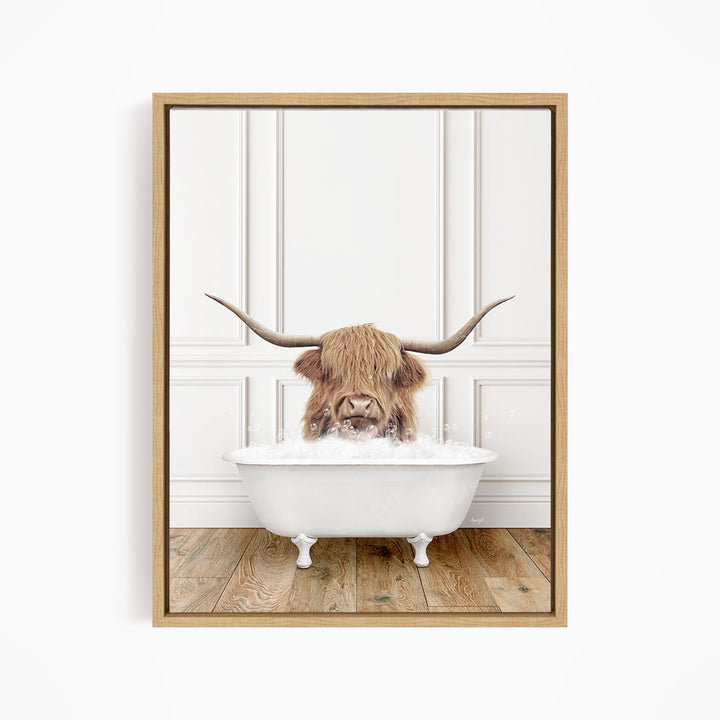 A Highland cow with long horns is sitting in a white bathtub, appearing to enjoy the bath.