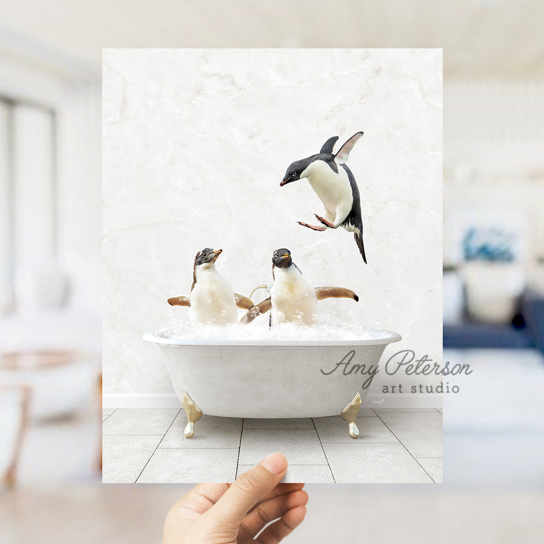 a hand holding up a card with penguins in a bathtub