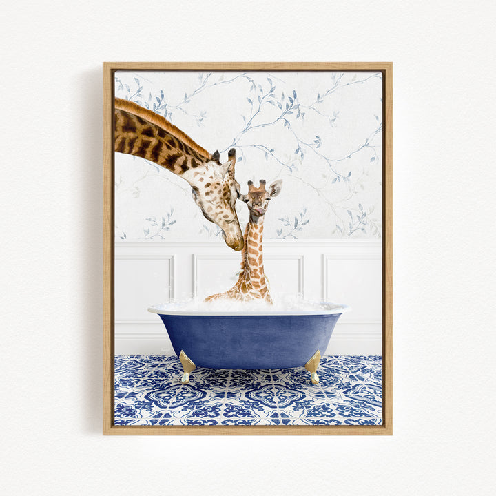 A mother giraffe and her baby giraffe are sitting together in a blue bathtub, with the mother gently licking her baby.