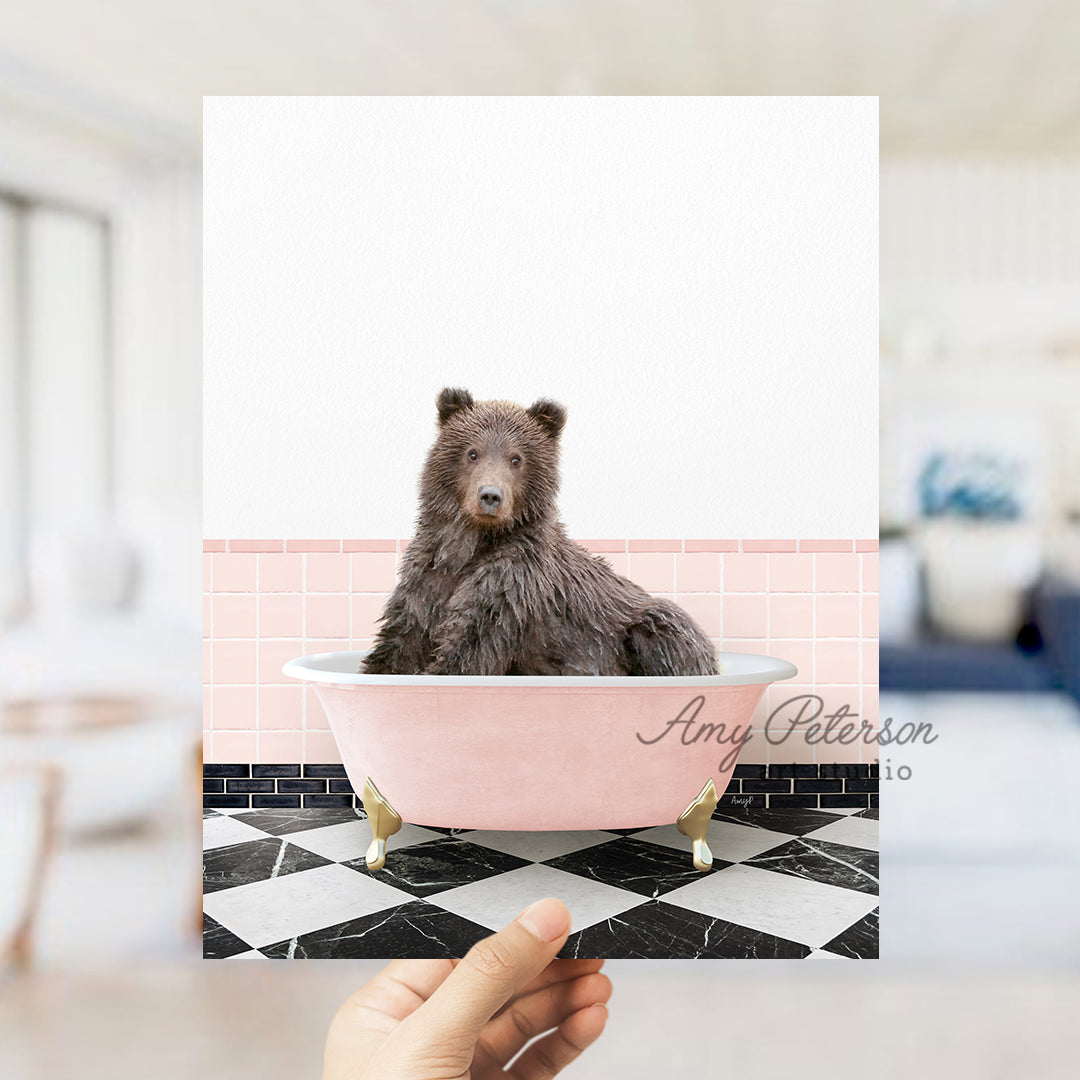 a person holding up a card with a picture of a bear in a bathtub