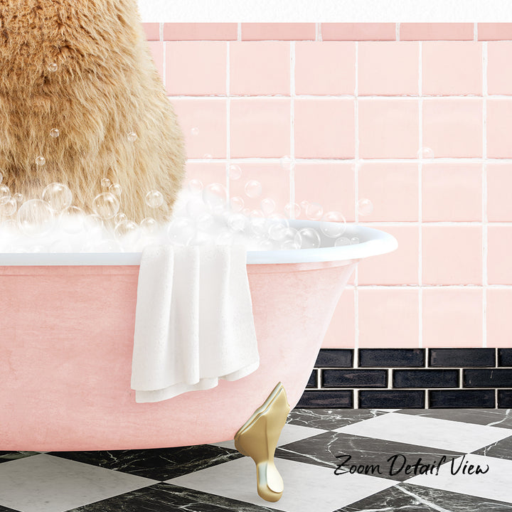 A fluffy brown cat is sitting in a pink bathtub filled with bubbles, with a white towel hanging on the side and a pink tile wall in the background.