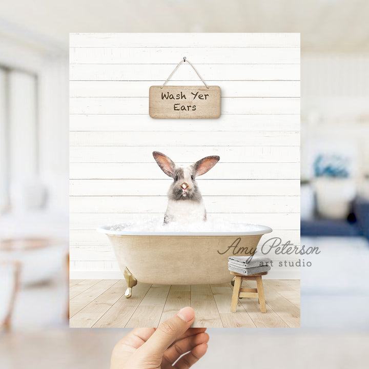 a rabbit in a bathtub with a sign hanging above it