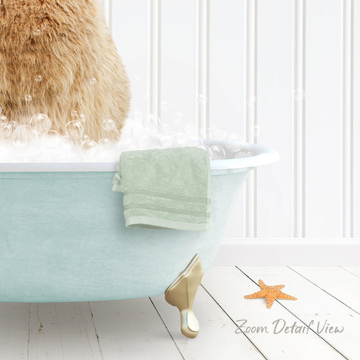 A cat sitting in a bathtub filled with bubbles, with a towel and starfish nearby.