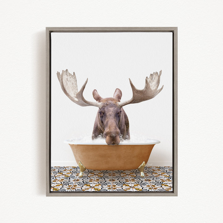 A moose with large antlers is sitting in a bathtub filled with water, creating a whimsical and humorous scene.