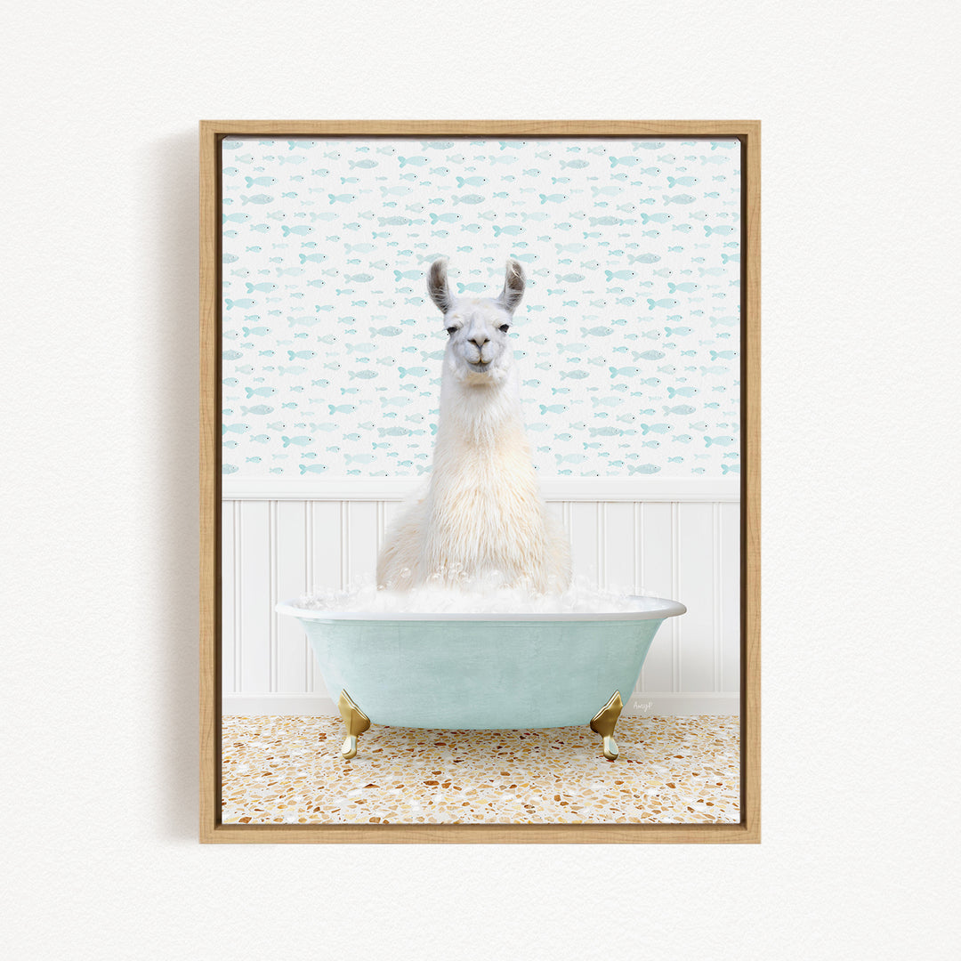 A white llama sitting in a light blue bathtub filled with bubbles, surrounded by a pattern of small fish on the wall behind it.