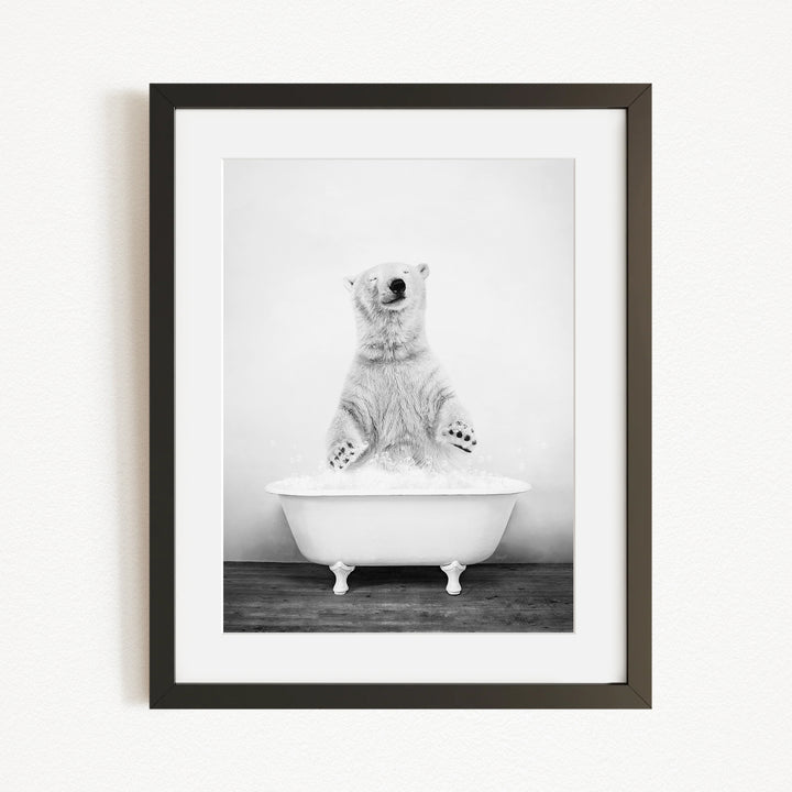 A polar bear standing in a bathtub filled with water, appearing to be enjoying a bath.