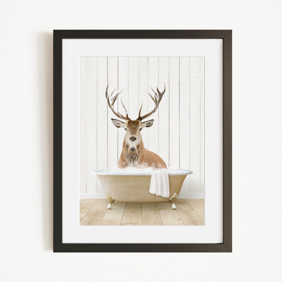 A deer with large antlers is sitting in a bathtub filled with water, creating a whimsical and unexpected scene.