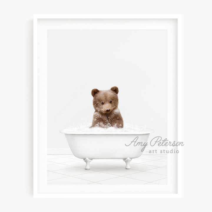 a brown teddy bear sitting in a bath tub