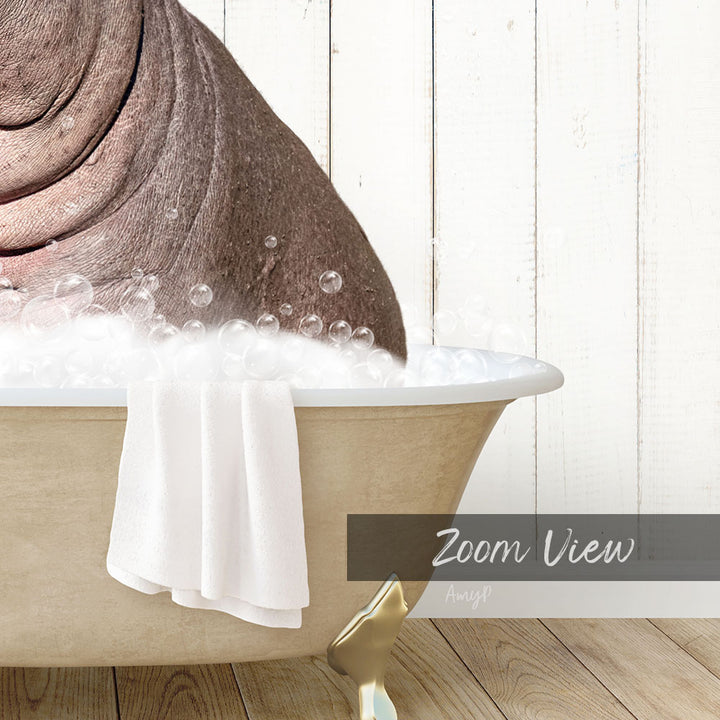 A bathtub filled with bubbles, with a towel draped over the side and a wooden floor visible in the background.