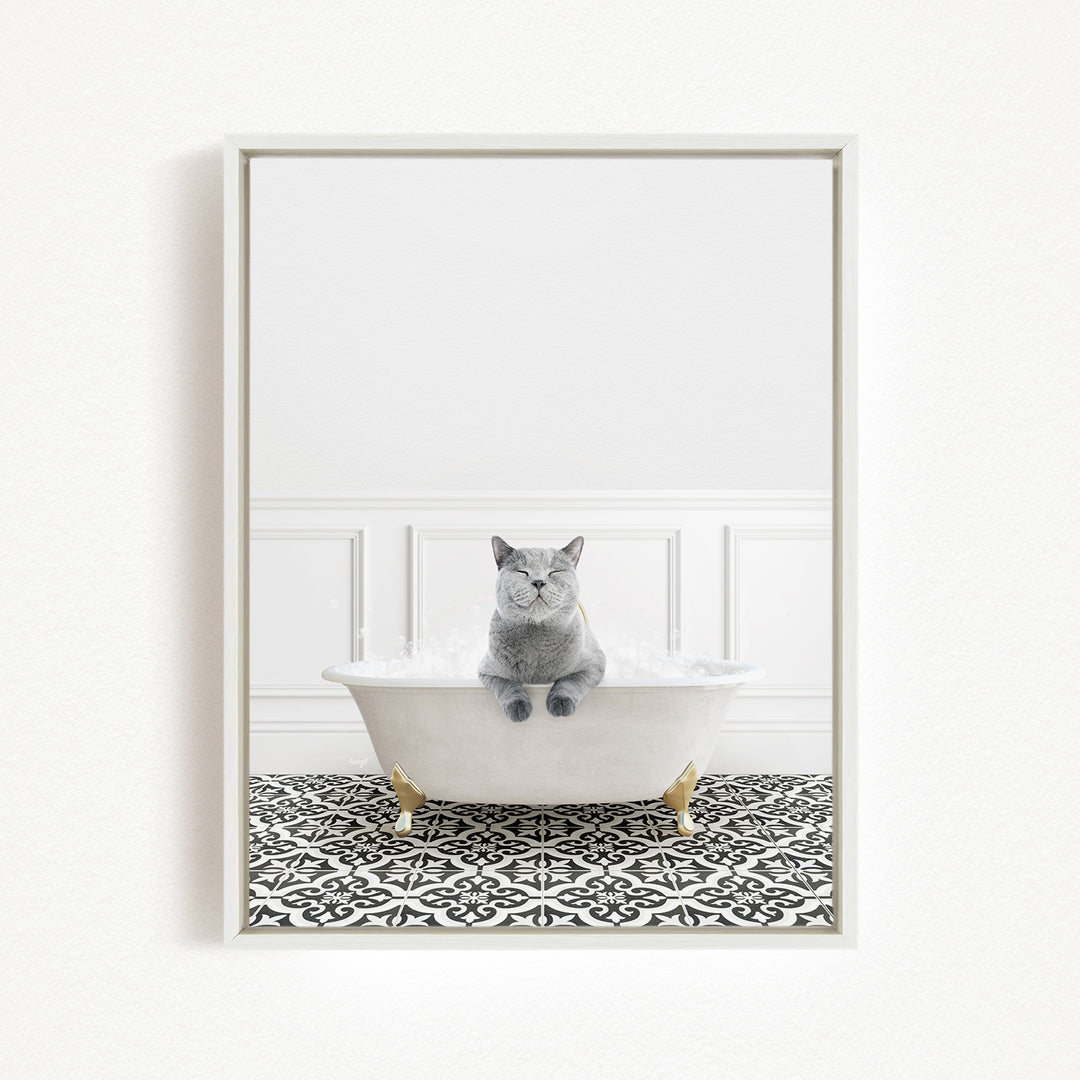 A gray cat sitting in a white bathtub filled with bubbles, with a black and white patterned floor in the background.