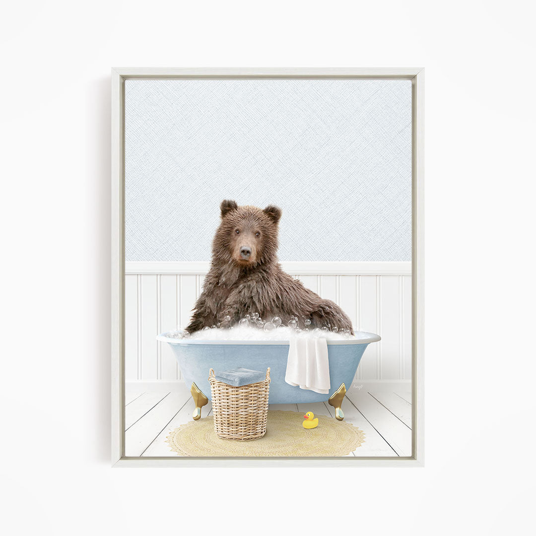 A brown bear sitting in a blue bathtub filled with water, surrounded by a yellow rubber duck and a wicker basket.