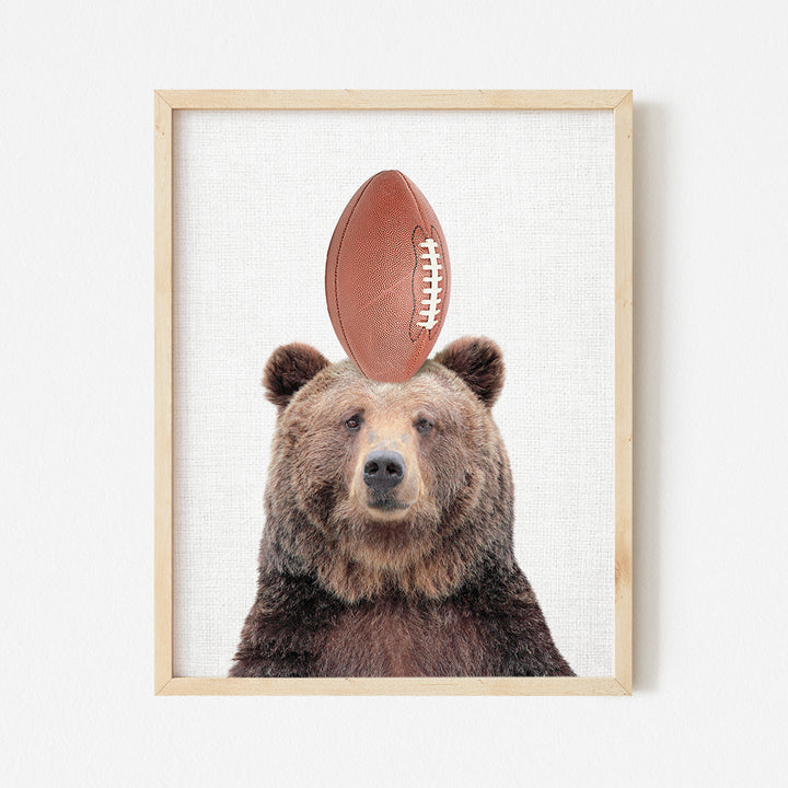 a picture of a bear with a football on its head