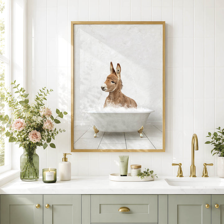 a bathroom with a framed picture of a donkey sitting in a bathtub, surrounded by flowers and candles.