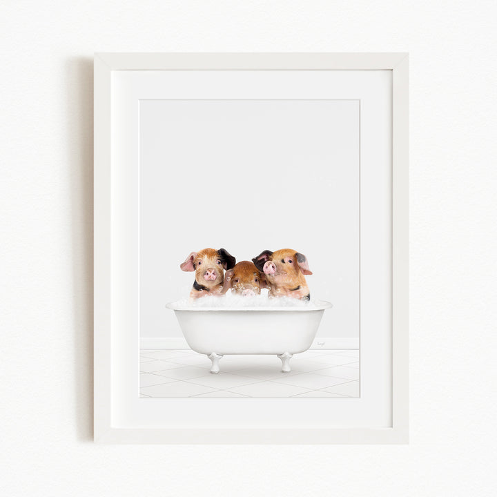 Three adorable brown and white pigs sitting in a white bathtub, enjoying a relaxing bath.