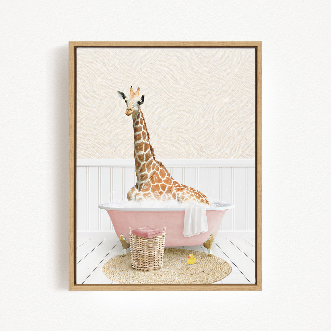 A giraffe sitting in a pink bathtub filled with water, surrounded by a basket of toys and a yellow rubber duck.