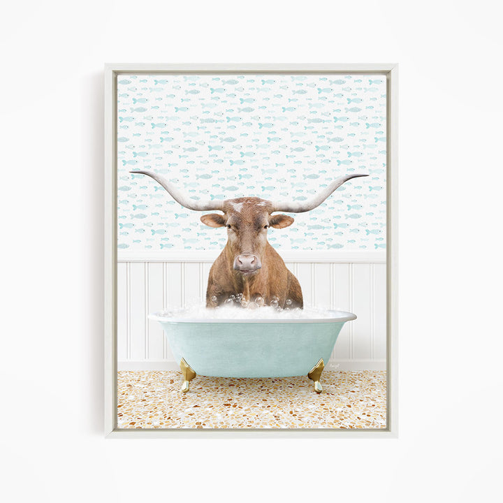 A brown cow with large horns is sitting in a light blue bathtub filled with bubbles, surrounded by a patterned wall.