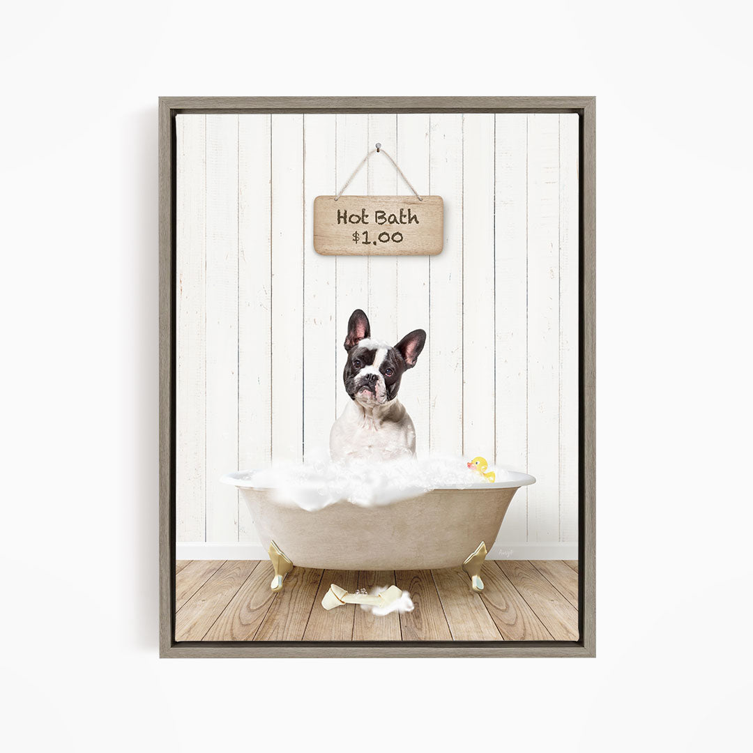 A French Bulldog sitting in a bathtub filled with bubbles, with a sign above the tub indicating a hot bath for $1.00.