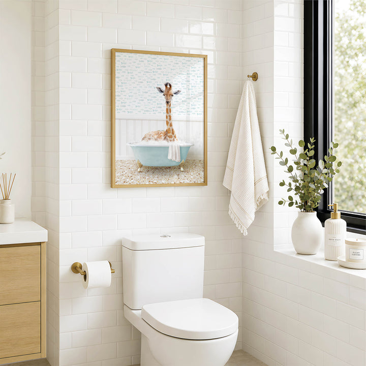 a bathroom with a white toilet, a framed picture of a giraffe in a bathtub, and a towel hanging on the wall.