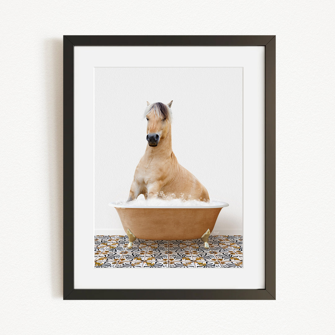 A light brown horse is sitting in a bathtub filled with water, surrounded by a patterned tile floor.