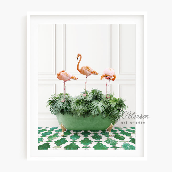 three pink flamingos in a green planter