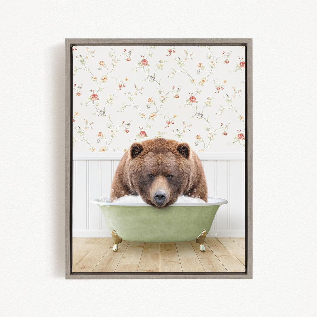A brown bear is sitting in a green bathtub, with a floral wallpaper in the background.