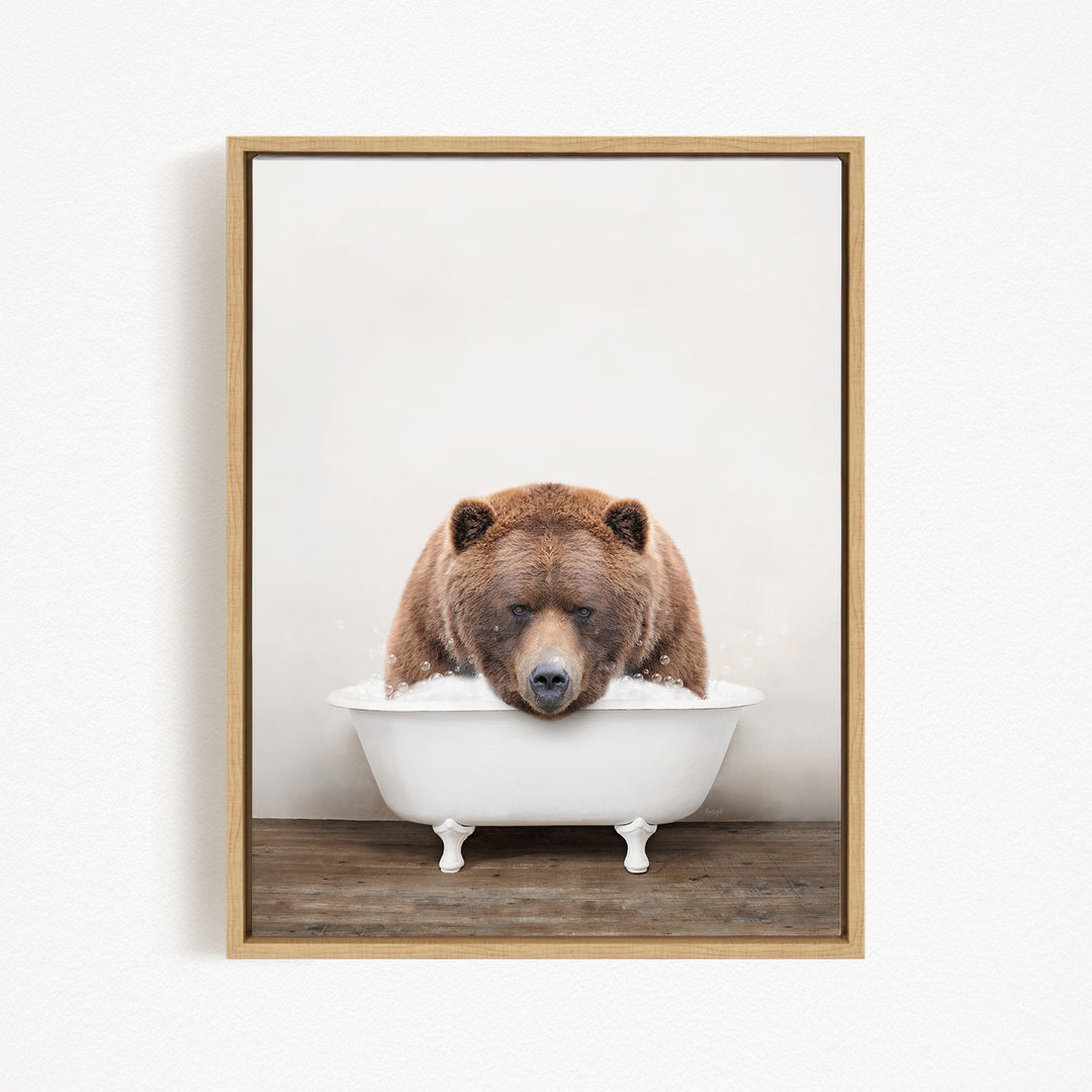 A brown bear sitting in a white bathtub, appearing to be enjoying a relaxing bath.