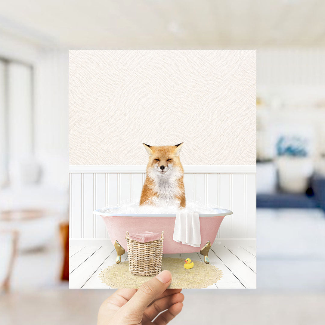 A fox is sitting in a pink bathtub filled with bubbles, surrounded by a yellow rubber duck and a white towel.