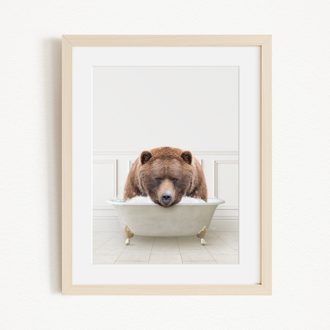 A brown bear is sitting in a white bathtub, appearing to be enjoying a relaxing bath.