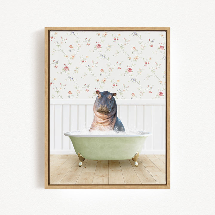 A hippopotamus sitting in a green bathtub filled with water, surrounded by a floral wallpaper.