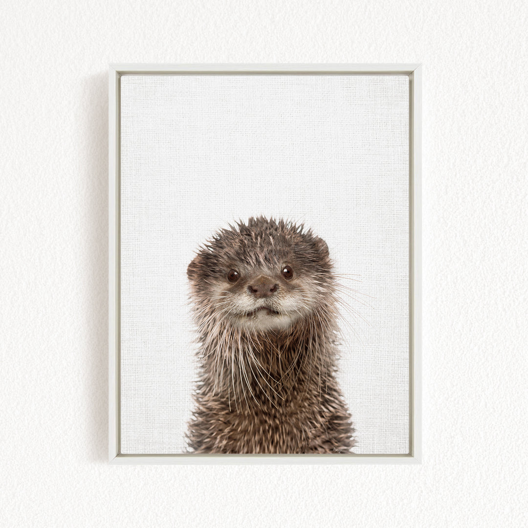 A close-up portrait of an otter with a curious expression, its wet fur and whiskers clearly visible.