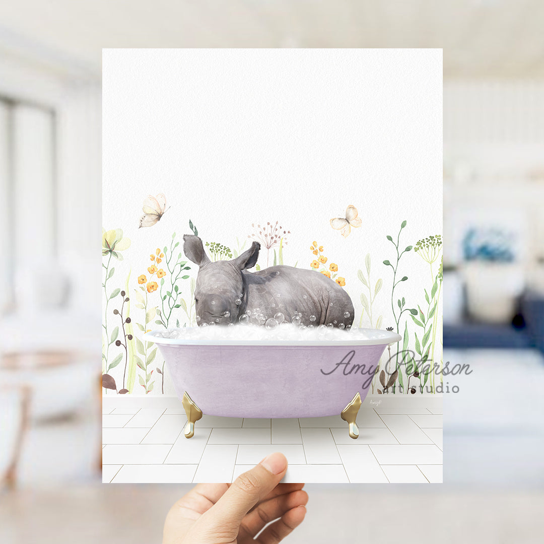 a hand holding up a card with a rhino in a bathtub