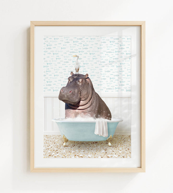 A framed image depicting a hippopotamus sitting in a bathtub, with a seagull perched on its head.