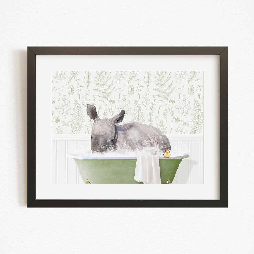 A rhinoceros is sitting in a green bathtub filled with water, surrounded by a patterned wallpaper.