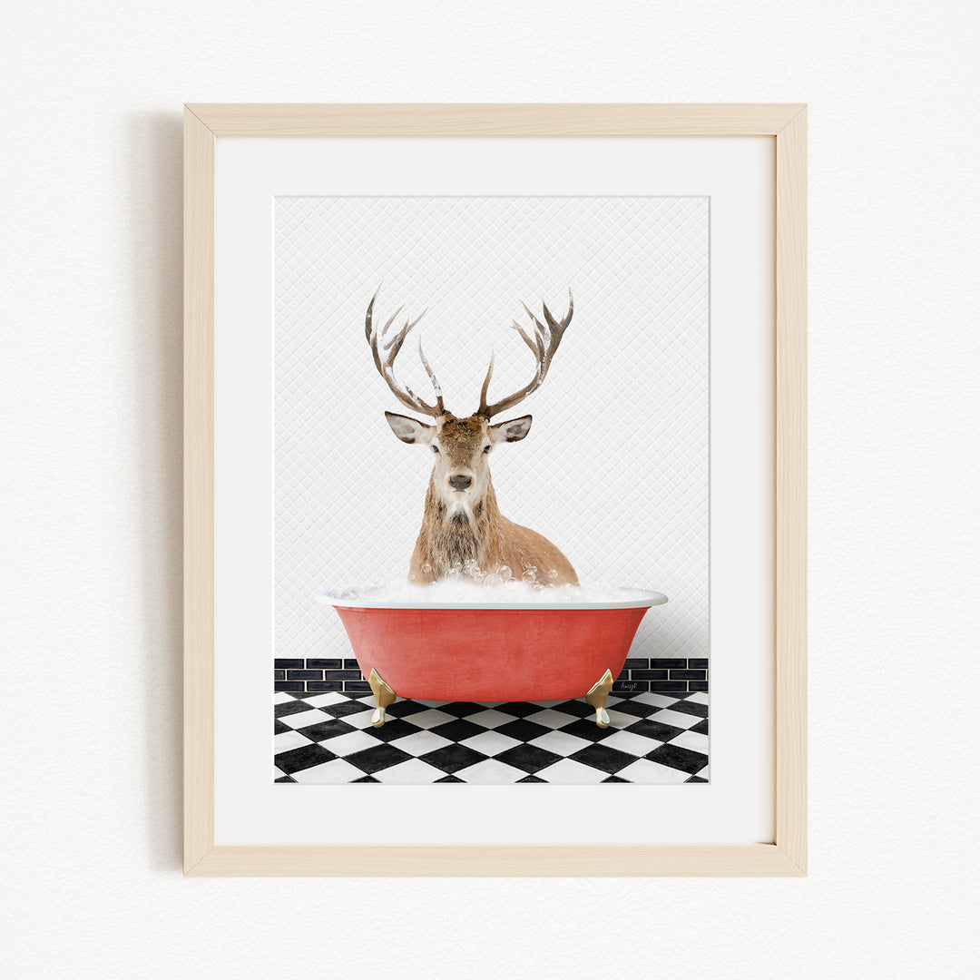 A deer with large antlers is sitting in a red bathtub filled with water, surrounded by a black and white checkered floor.