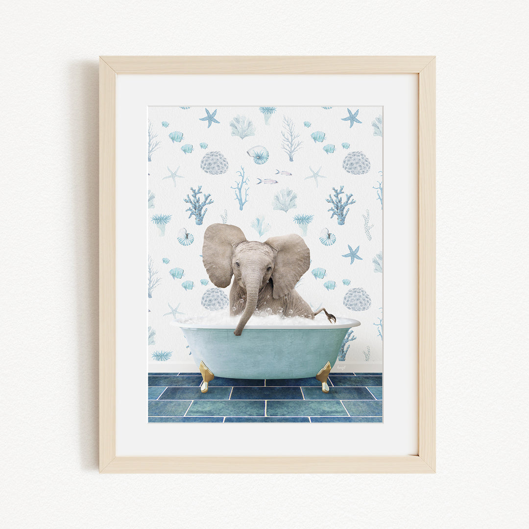 A framed image depicting a baby elephant sitting in a bathtub filled with water, surrounded by blue and white seashells and starfish.