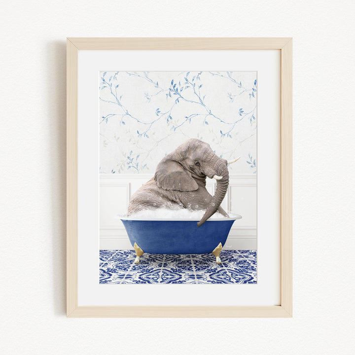 A gray elephant is sitting in a blue bathtub filled with water, surrounded by a blue and white patterned tile floor.