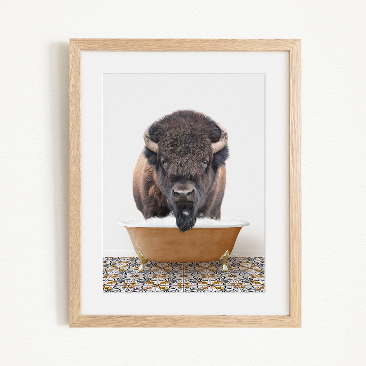 A buffalo with large horns is standing in a bathtub filled with water, creating a playful and whimsical scene.