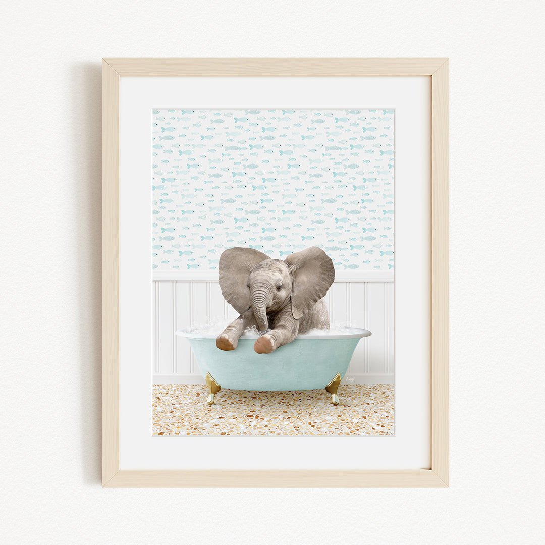A baby elephant sitting in a light blue bathtub, with its trunk raised and ears flapping, against a background of blue and white fish.