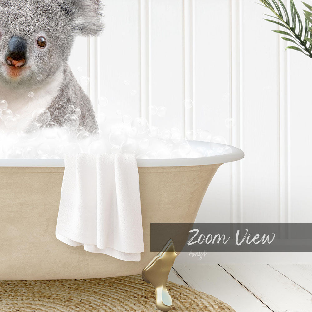 A koala bear sitting in a bathtub filled with bubbles, with a towel and a plant nearby.