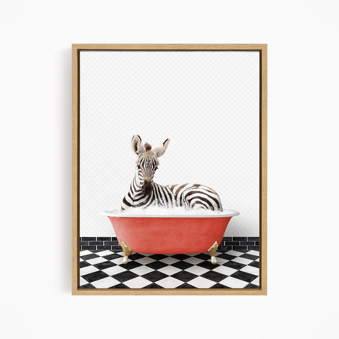 A zebra is sitting in a red bathtub on a black and white checkered floor.