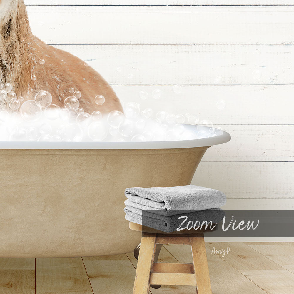 A dog is sitting in a bathtub filled with bubbles, with a towel and stool nearby.