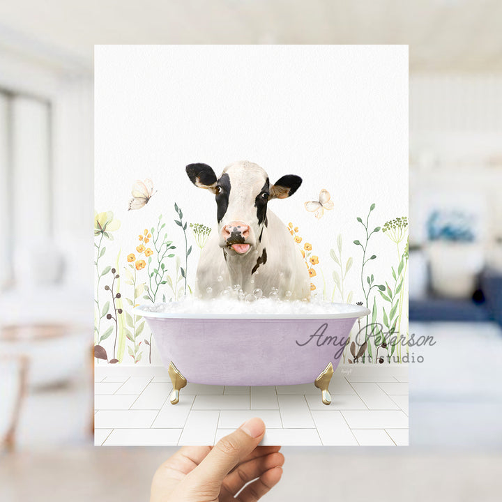 a person holding up a card with a picture of a cow in a bathtub