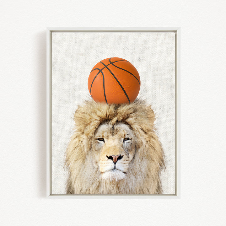 A framed image of a lion with a basketball on its head.