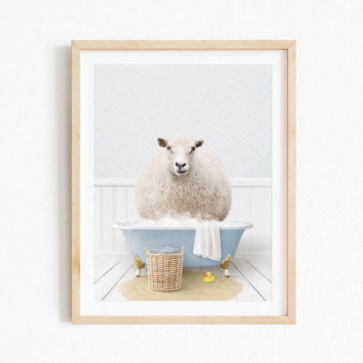 A fluffy white sheep sits in a blue bathtub filled with bubbles, surrounded by a yellow rubber duck and a wicker basket.