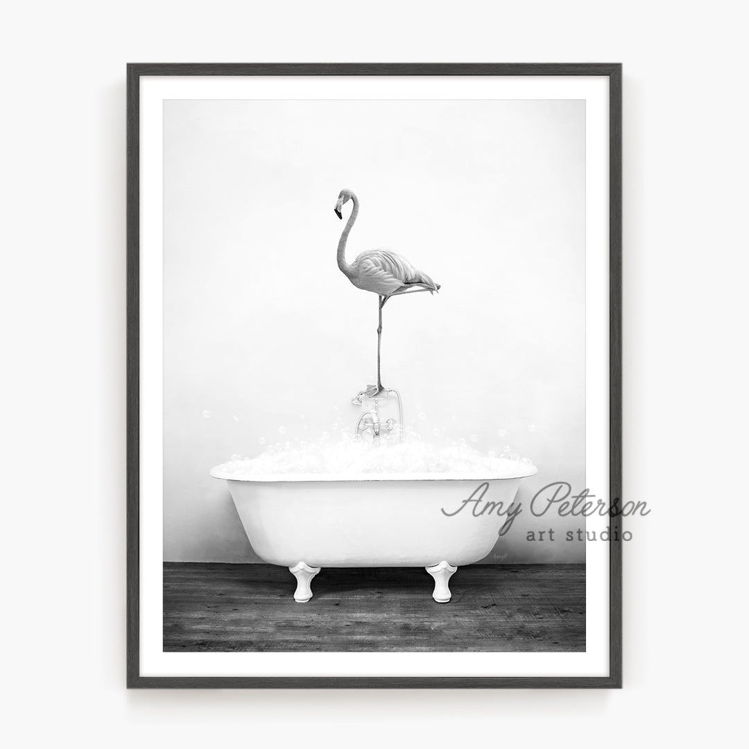 a black and white photo of a flamingo in a bathtub