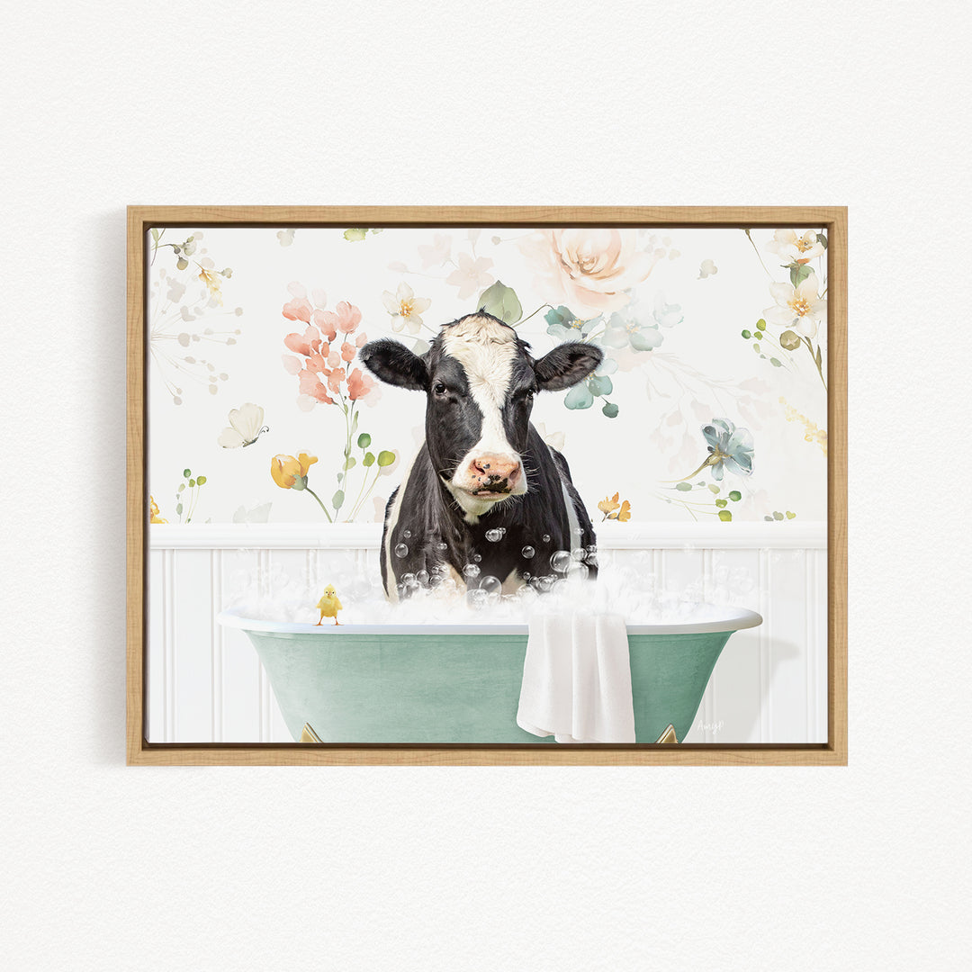 A black and white cow is sitting in a green bathtub filled with bubbles, surrounded by a floral wallpaper.