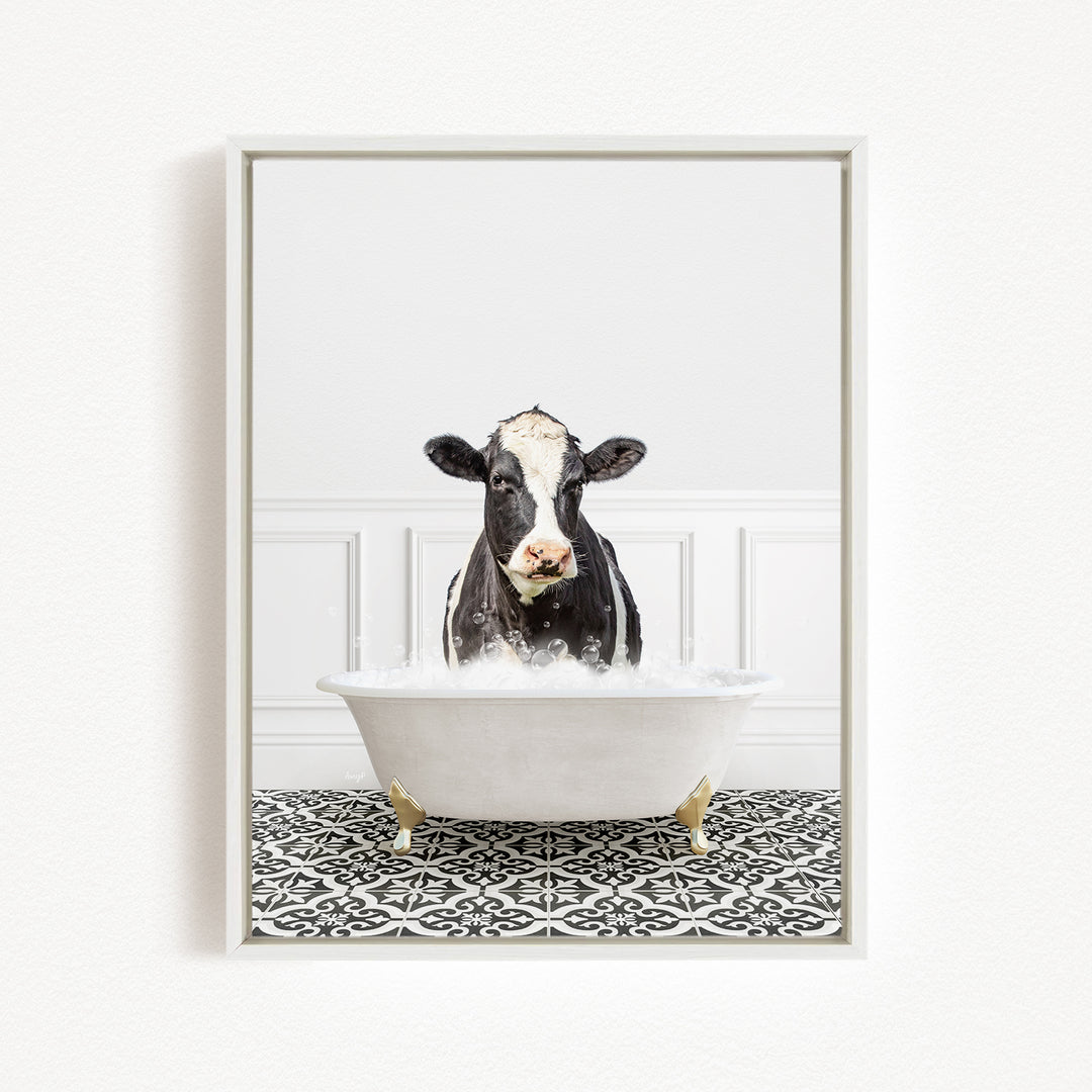 A black and white cow is standing in a white bathtub filled with water, creating a whimsical and playful scene.