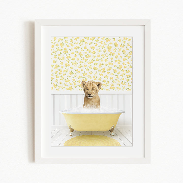 A young lion cub sitting in a yellow bathtub filled with water, surrounded by a yellow floral wallpaper.