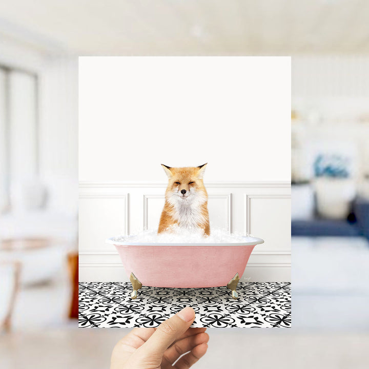 A fox is sitting in a pink bathtub filled with bubbles, looking directly at the camera.